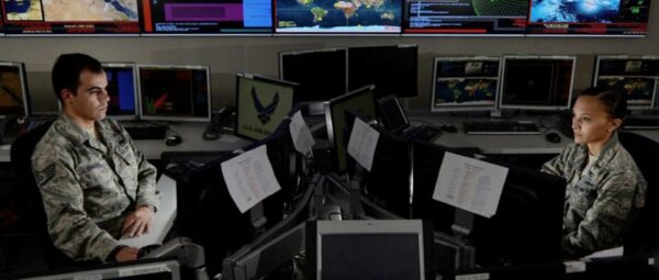 Two soldiers watching computer screens
